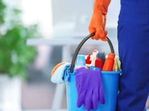 Cleaning professional with supplies from bellevuecleans offering affordable cleaning services in Bellevue.