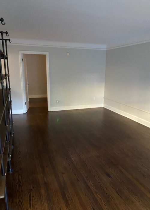 Clean and polished hardwood floors in an empty room after professional service by BellevueCleans — expert construction cleaning services in Bellevue.